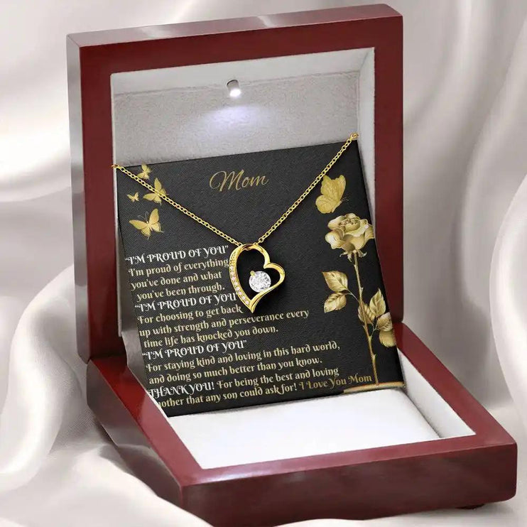 yellow gold forever love necklace in mahogany box angled left