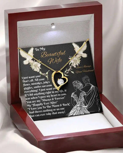 yellow gold forever love necklace in a mahogany box angled left