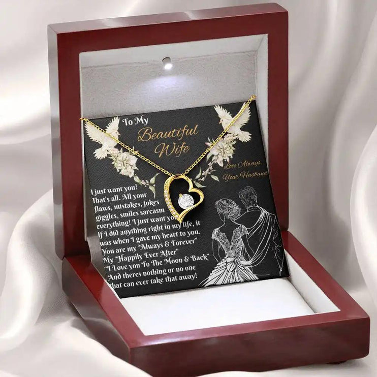 yellow gold forever love necklace in a mahogany box angled left