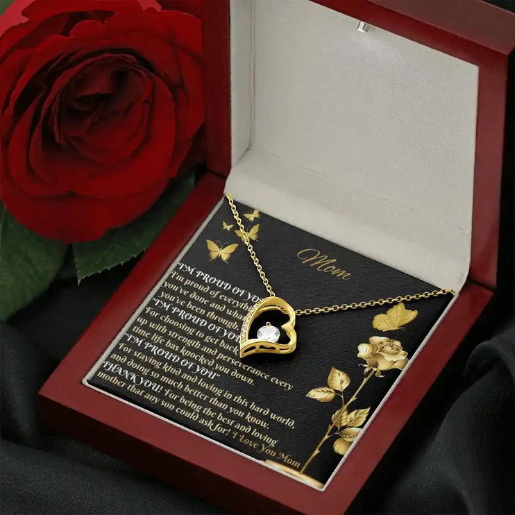 yellow gold forever love necklace in mahogany box angled right