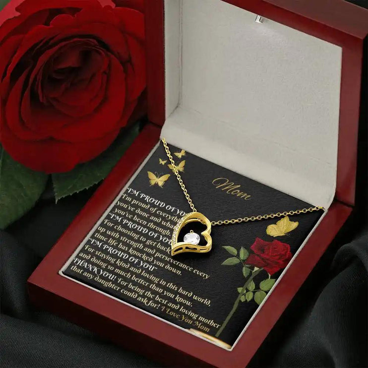 yellow gold forever love necklace in mahogany box angled right