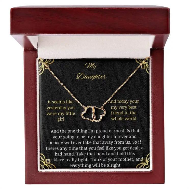 Everlasting Love Necklace in a mahogany box with a to daughter from mother greeting card with angle looking down