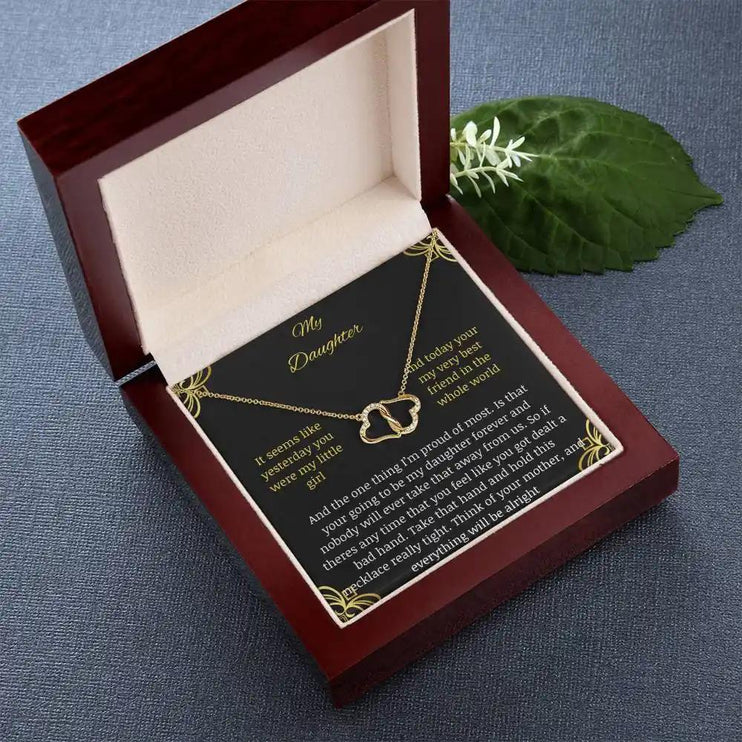 Everlasting Love Necklace in a mahogany box with a to daughter from mother greeting card with angle tilted to right