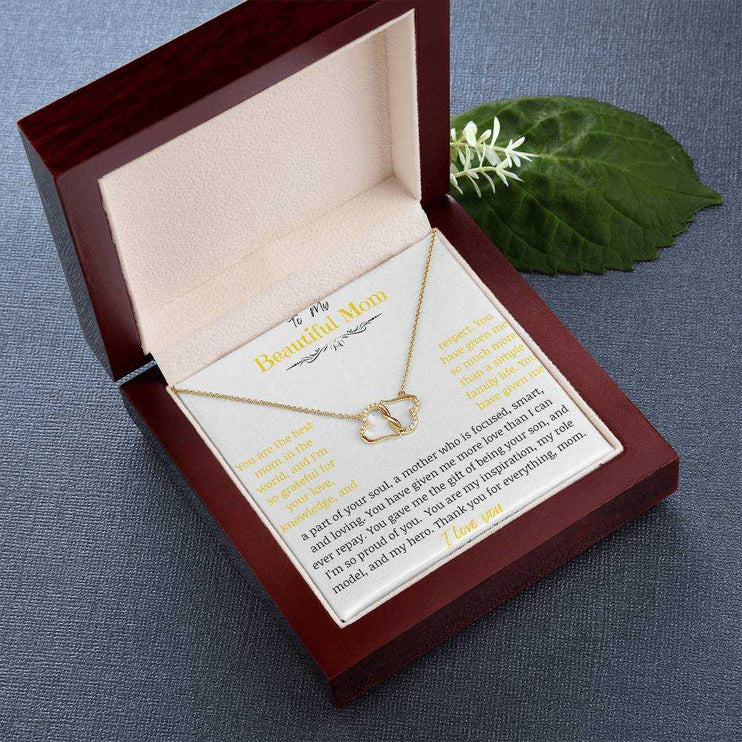 A everlasting love necklace in a mahogany box on a table.