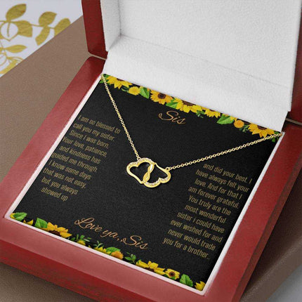 Everlasting Love Necklace with a to sis from sis greeting card inside a mahogany box sitting on a wood grain tableup close view