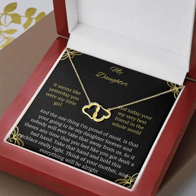 Everlasting Love Necklace in a mahogany box with a to daughter from mother greeting card with angle tilted left but close up