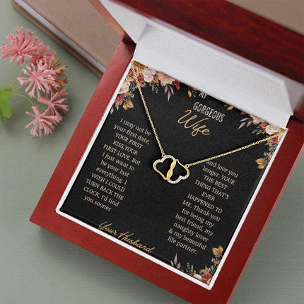  A 10k gold Everlasting Love Necklace in a mahogany box on a table with a to wife greeting card