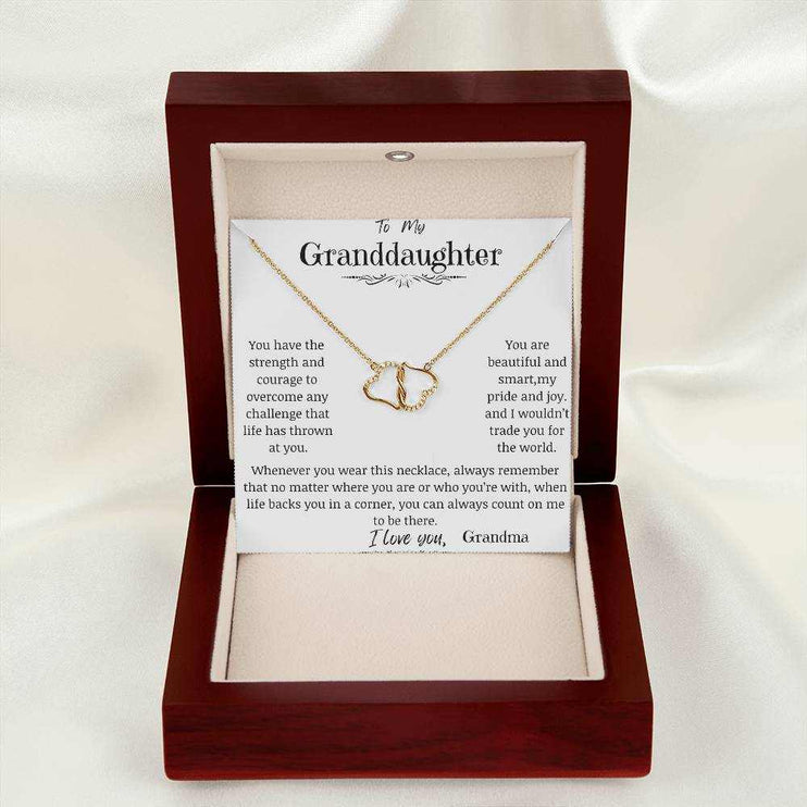 a everlasting love necklace in a mahogany box on a white cloth