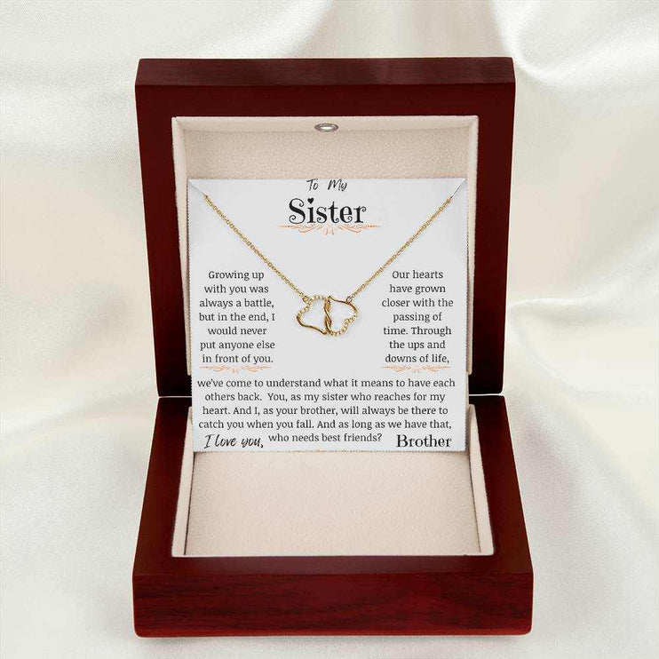 a 10k everlasting love necklace in a mahogany box on a white cloth