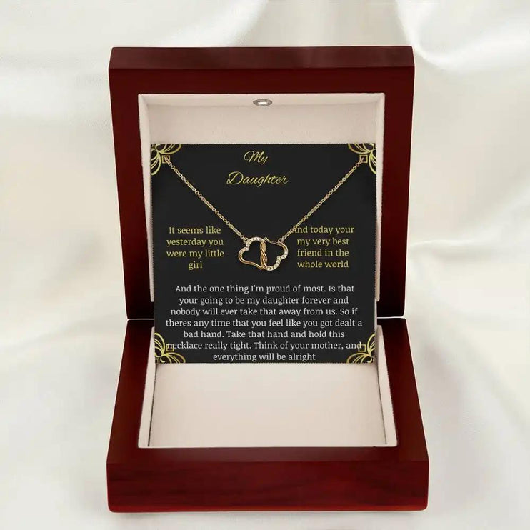 Everlasting Love Necklace in a mahogany box with a to daughter from mother greeting card with angle down low looking straight frorward