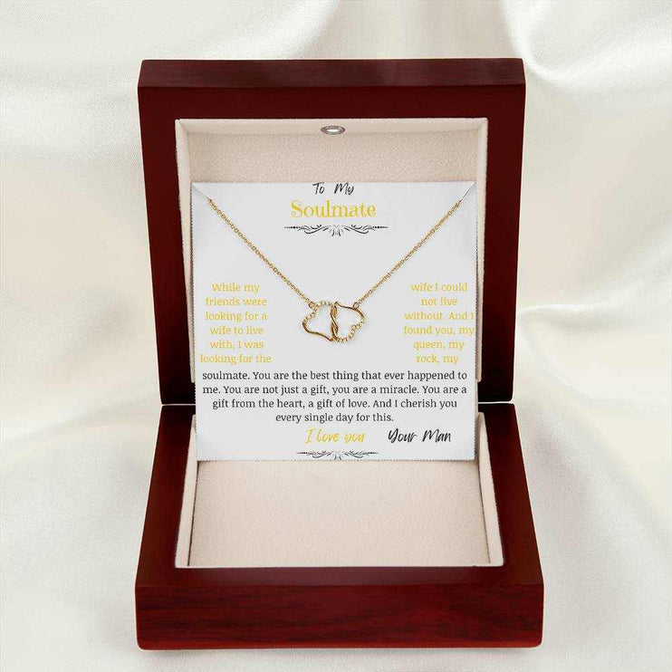 A everlasting love necklace in a mahogany box on a white cloth