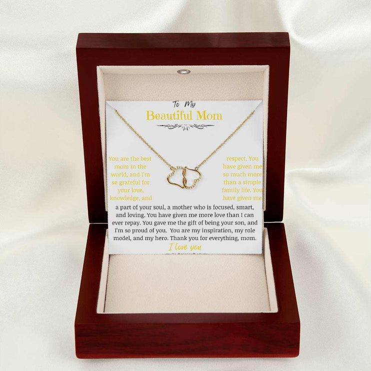 A everlasting love necklace in a mahogany box on a white cloth.