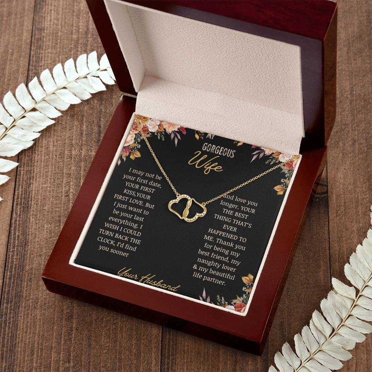  A 10k gold Everlasting Love Necklace in a mahogany box on a table with a to wife greeting card