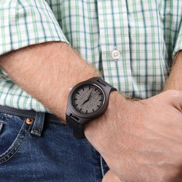 wooden watch engraved on a model's wrist