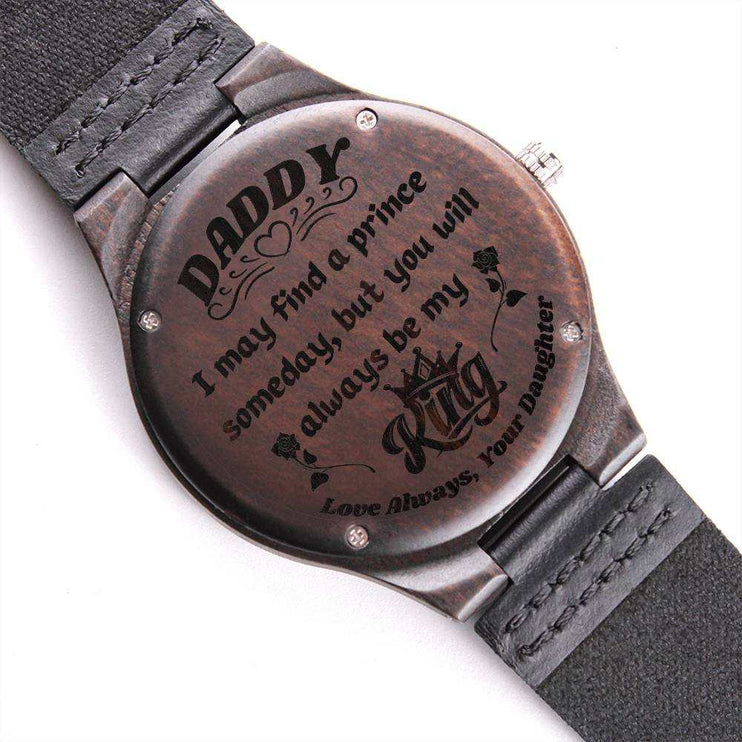 wooden watch engraved on a white back drop showing engraved side