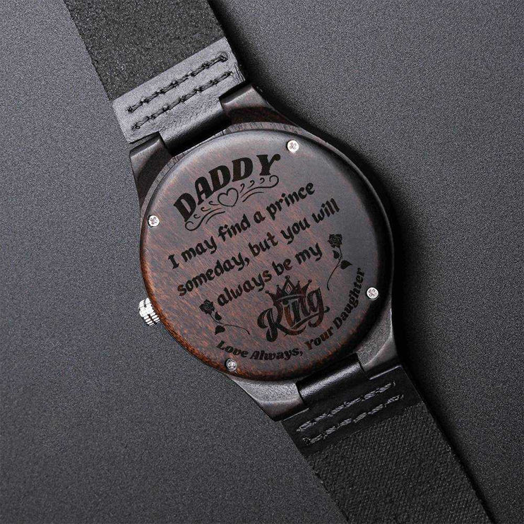 wooden watch engraved on a black back drop