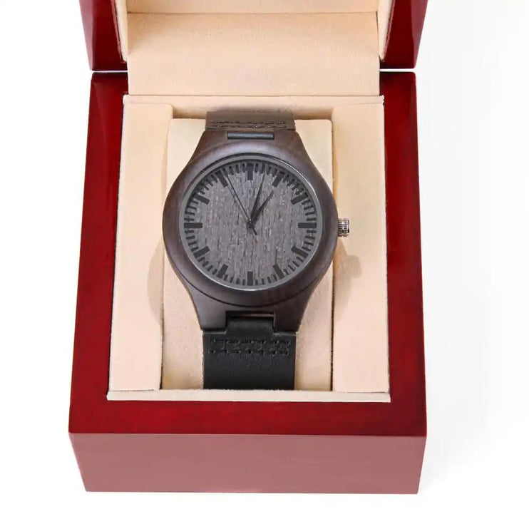 A engraved wooden watch in a mahogany box
