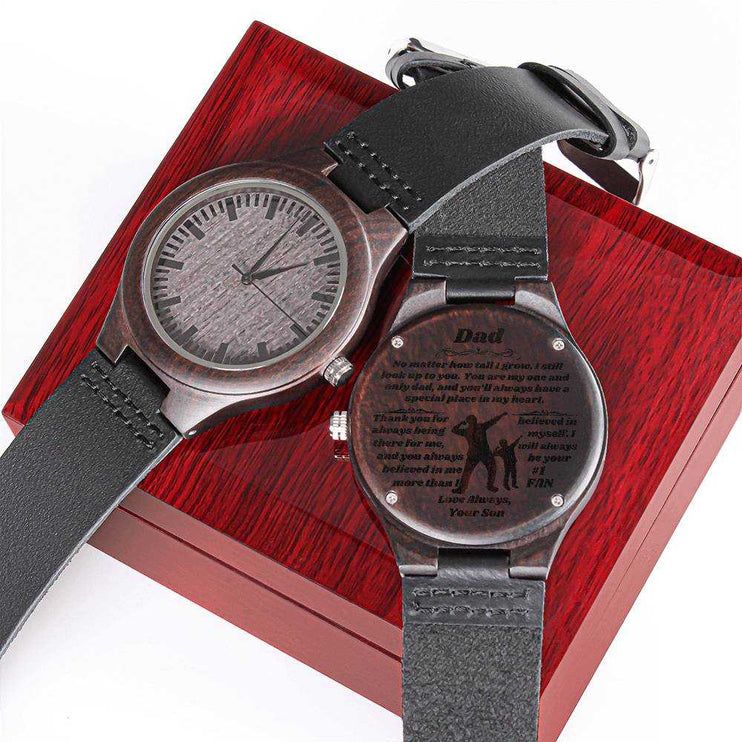 wooden watch engraved on top of a closed luxury box showing both sides