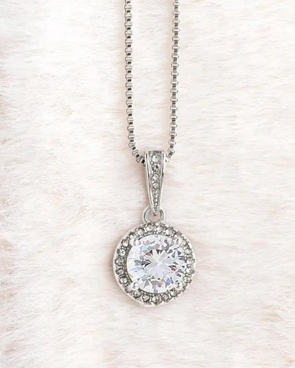 white gold eternal hope necklace on a white fleece