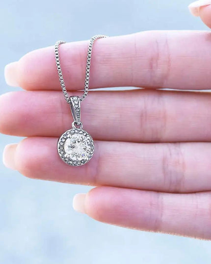white gold eternal hope necklace on models hand