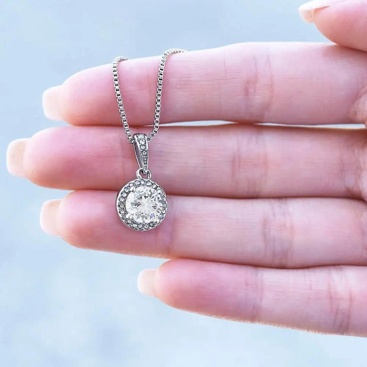 white gold eternal hope necklace on models hand