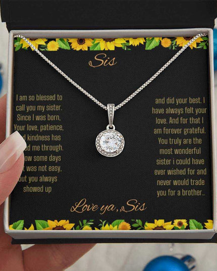 Eternal Hope Necklace on a To Sis from Sis greeting card in a two-tone box close up view in the hand of a model.