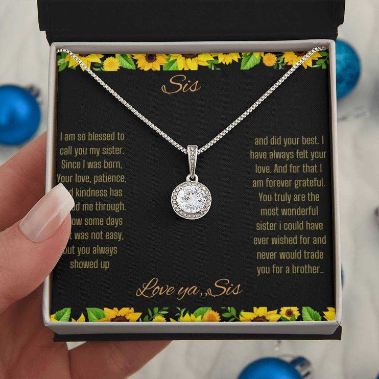 Eternal Hope Necklace on a To Sis from Sis greeting card in a two-tone box close up view in the hand of a model.