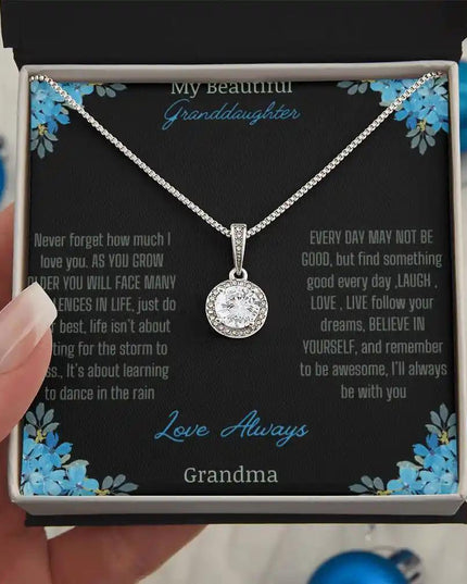 Eternal Hope Necklace with a to granddaughter from grandpa greeting card in a two-tone box models hand