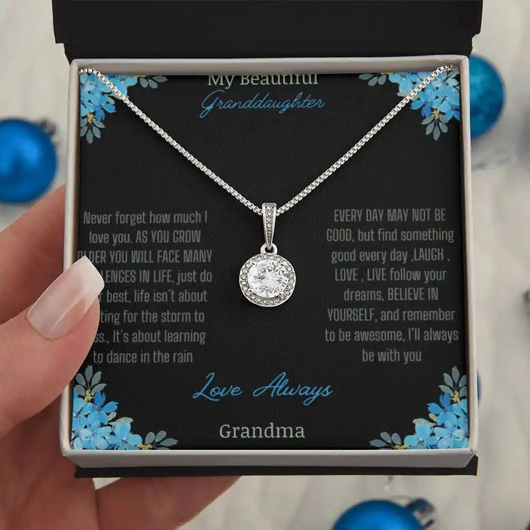 Eternal Hope Necklace with a to granddaughter from grandpa greeting card in a two-tone box models hand