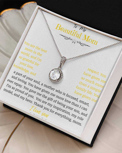 A white gold eternal hope necklace close up in a two-tone box on a coffee filter