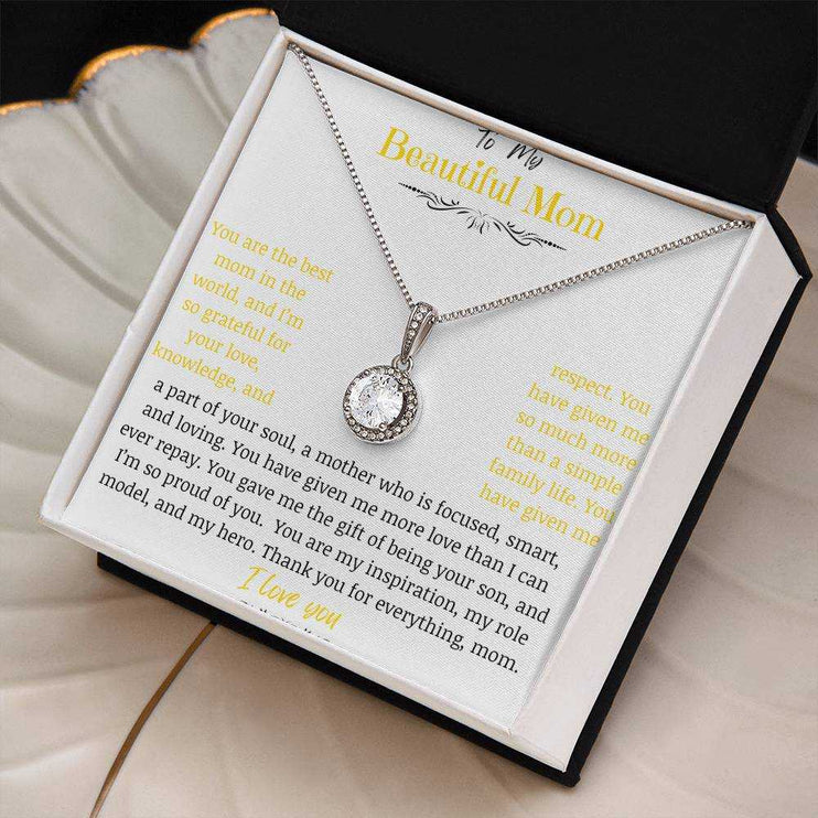 A white gold eternal hope necklace close up in a two-tone box on a coffee filter