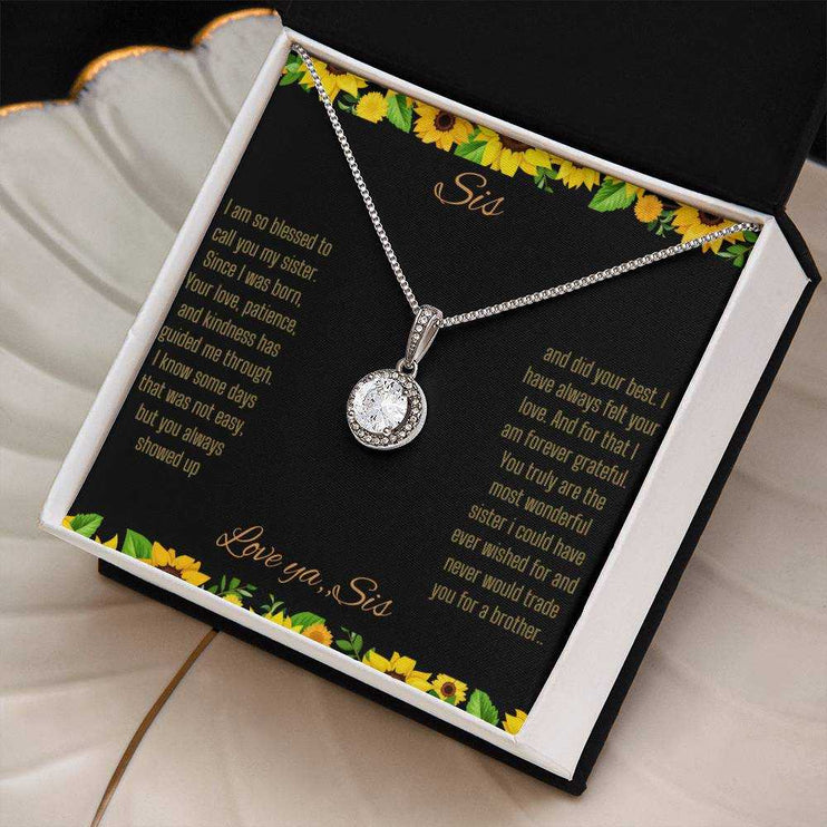 Eternal Hope Necklace on a To Sis from Sis greeting card in a two-tone box angled to the right sitting on a coffee filter.