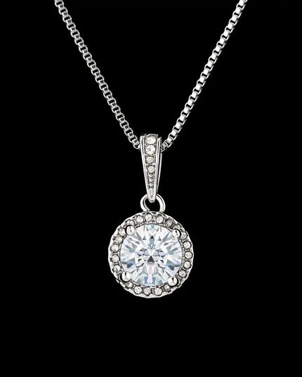 white gold eternal hope necklace on a black back drop