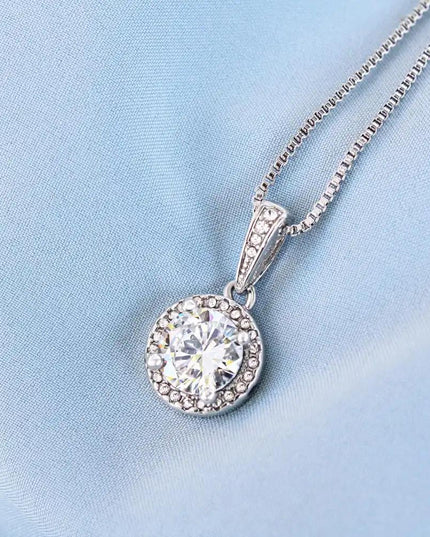 white gold eternal hope necklace on a blue cloth