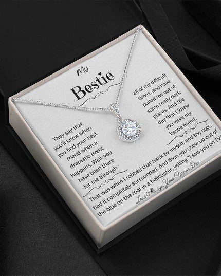 a eternal hope necklace up close in a dark background