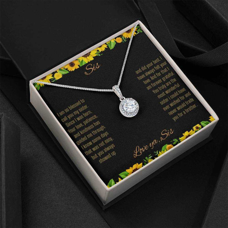 Eternal Hope Necklace on a To Sis from Sis greeting card in a two-tone box sitting on a black back drop close up view.