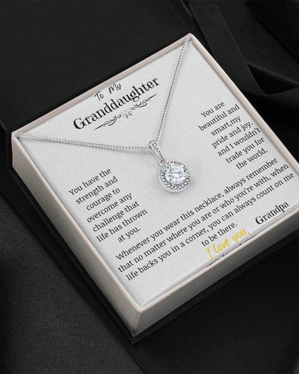 a white gold eternal hope necklace up close in black background