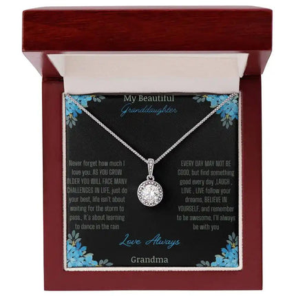 Eternal Hope Necklace with a to granddaughter from grandpa greeting card in a mahogany box on a white backdrop