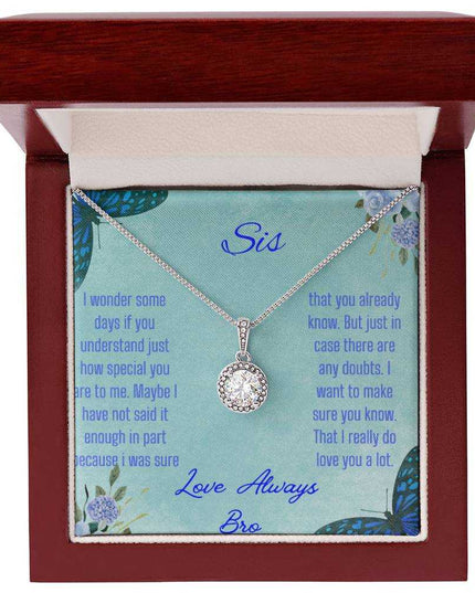 Eternal Hope Necklace on a To Sis from Bro greeting card in a mahogany box on a white background up close