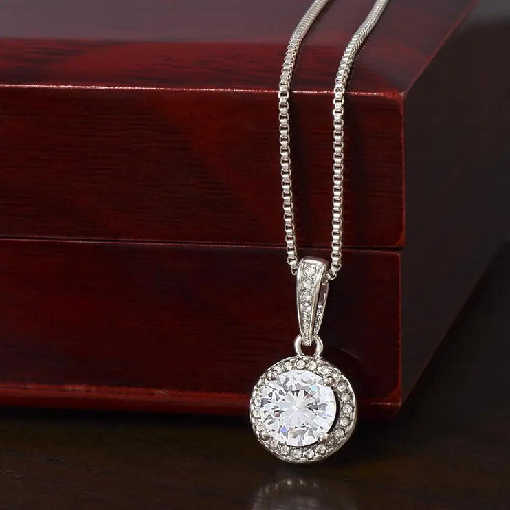 white gold eternal hope necklace on top of mahogany box