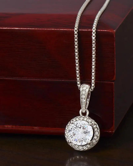 white gold eternal hope necklace on a mahogany box