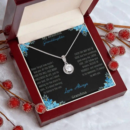 Eternal Hope Necklace with a to granddaughter from grandpa greeting card in a mahogany box on a white coffee filter angled to the right side