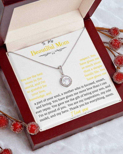 A white gold eternal hope necklace close up in a mahogany box on a coffee filter with red flower buds