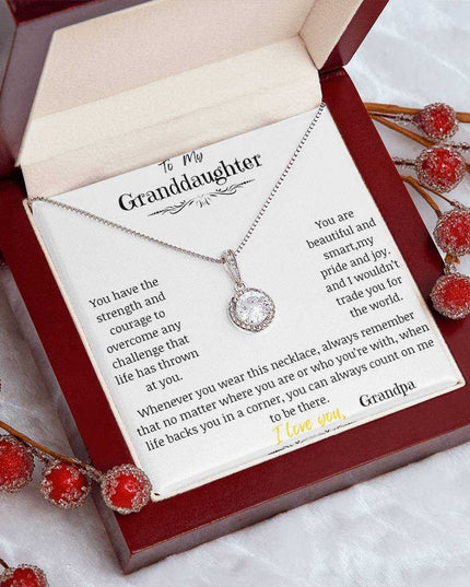 a white gold eternal hope necklace up close in a mahogany box on a coffee filter angled left