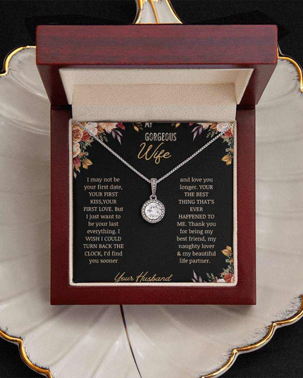 A white gold Eternal Hope Necklace on a to wife greeting card in a mahogany box on a coffee filter