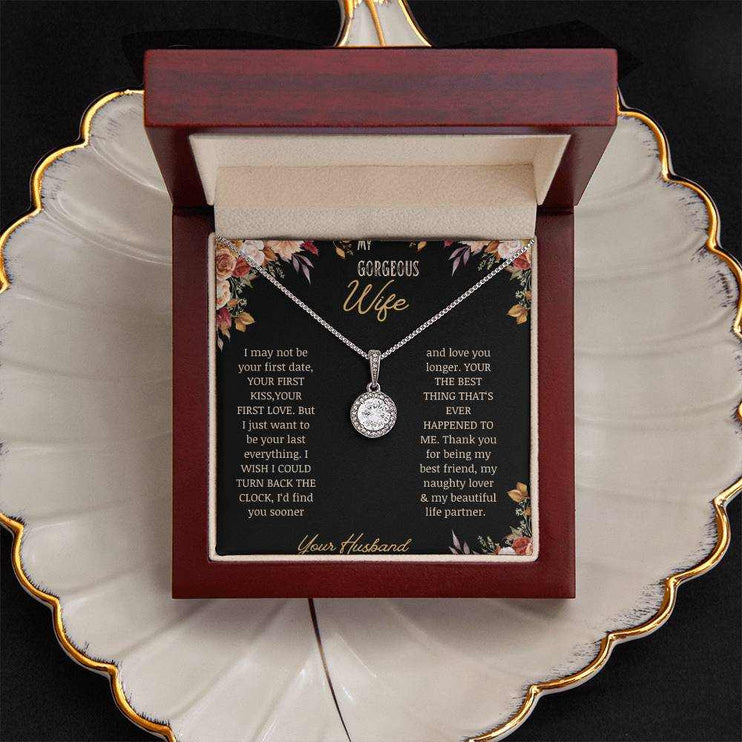 A white gold Eternal Hope Necklace on a to wife greeting card in a mahogany box on a coffee filter