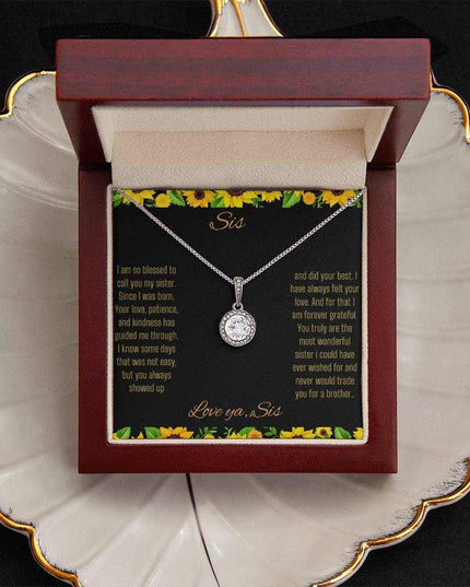 Eternal Hope Necklace on a To Sis from Sis greeting card in a mahogany box sitting on a coffee filter close up view.