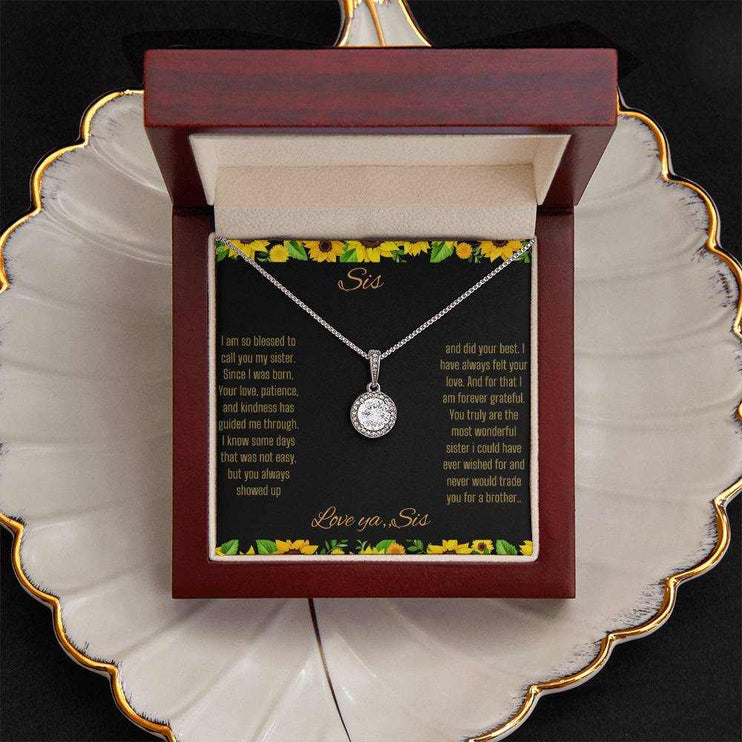 Eternal Hope Necklace on a To Sis from Sis greeting card in a mahogany box sitting on a coffee filter close up view.