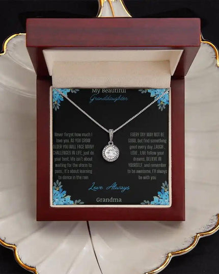 Eternal Hope Necklace with a to granddaughter from grandpa greeting card in a mahogany box on a white coffee filter