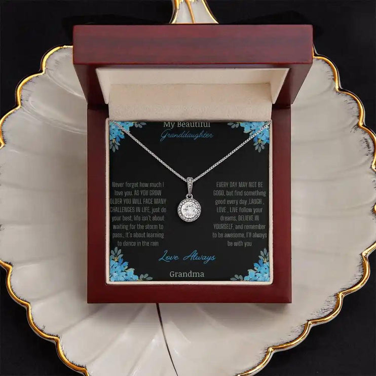 Eternal Hope Necklace with a to granddaughter from grandpa greeting card in a mahogany box on a white coffee filter